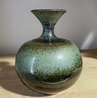Handmade wheel-thrown ceramic vase with mottled green glaze by Lisette Bedoya, pottery instructor at A Maker's Circle in Pottersville NJ