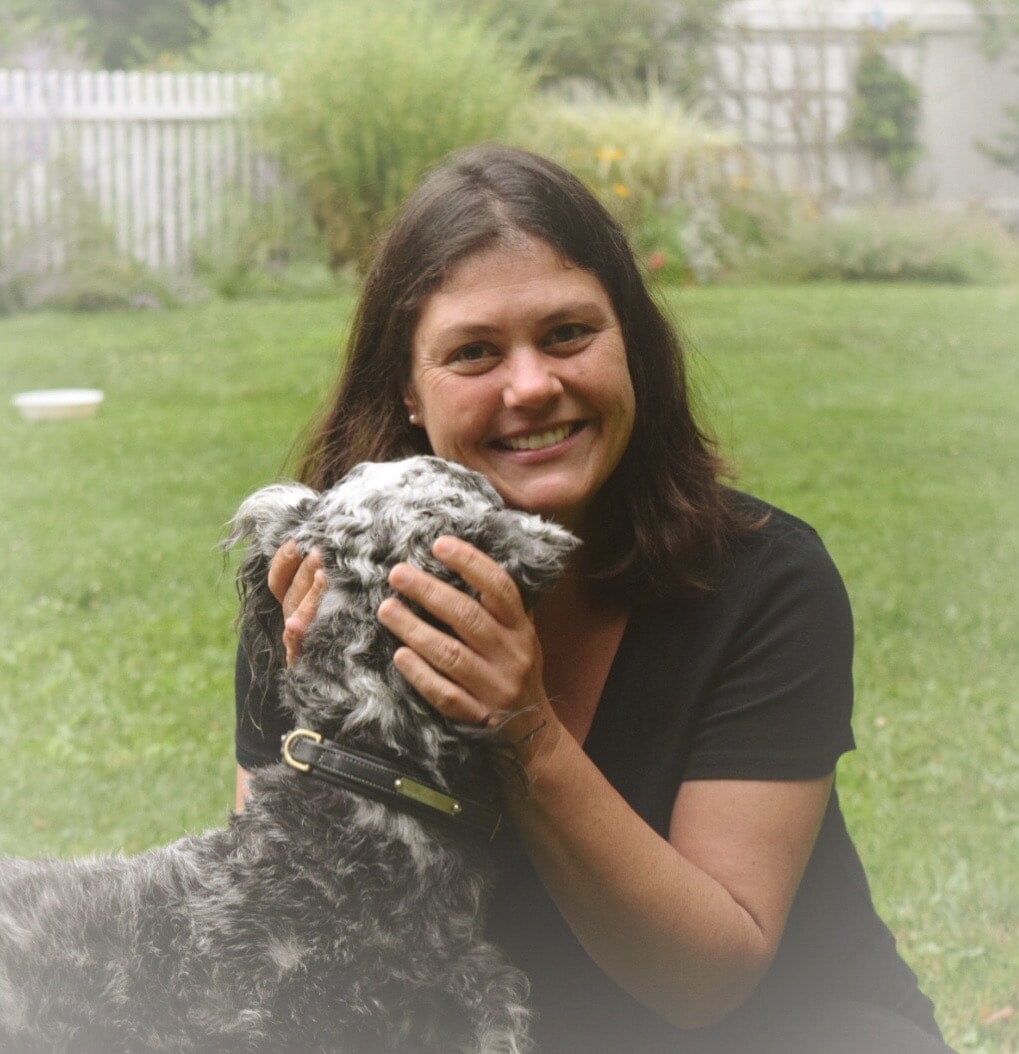 Laurie Scupp, pottery instructor at A Maker's Circle art studio in Pottersville NJ, smiling outdoors with her dog