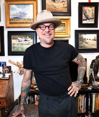 Dan Marshall, guest watercolor workshop instructor at A Maker's Circle in Pottersville NJ, smiling in his art studio surrounded by award-winning paintings